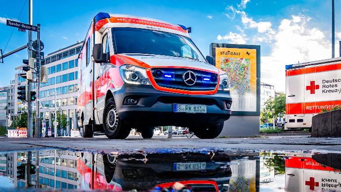 white and red Mercedes-Benz ambulace